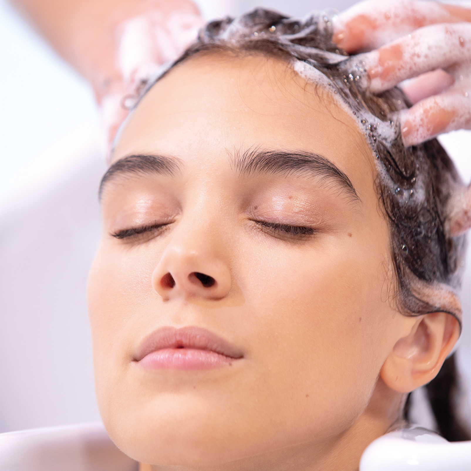 Woman using RESTART Hydration Shampoo from Revlon